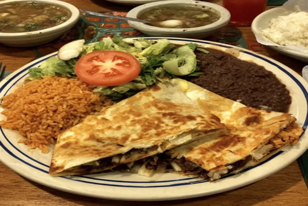 Birria ramen bowl with consommé at Birriería Obregón
