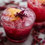 Hibiscus ginger mocktail in glass with lime and mint